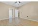 Second bedroom with hardwood floors and access to a bathroom at 6663 Queens Borough Ave # 108, Orlando, FL 32835