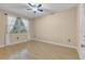 Bright bedroom with hardwood floors and a large window at 6663 Queens Borough Ave # 108, Orlando, FL 32835