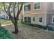 Back exterior view showing a condo building with a screened porch and a large tree at 6663 Queens Borough Ave # 108, Orlando, FL 32835