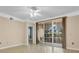 Living room features hardwood floors, sliding doors leading to a patio, and ample natural light at 6663 Queens Borough Ave # 108, Orlando, FL 32835