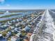 Beautiful aerial view of beach houses along the coast with ocean and inlet views on a sunny day at 6912 S Atlantic Ave, New Smyrna Beach, FL 32169