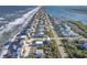 Expansive aerial view showcases oceanfront homes, beach, Intracoastal waterway and coastal landscape at 6912 S Atlantic Ave, New Smyrna Beach, FL 32169