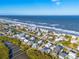 An aerial view of the stunning coastline, homes, beaches, and Atlantic ocean at 6912 S Atlantic Ave, New Smyrna Beach, FL 32169