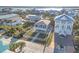 A stunning aerial view shows the house, front yard, fence and surrounding homes at 6912 S Atlantic Ave, New Smyrna Beach, FL 32169