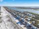 Panoramic aerial view of coastal homes, beach, waves, and Intracoastal waterway at 6912 S Atlantic Ave, New Smyrna Beach, FL 32169
