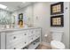Bright bathroom boasts double vanity with marble countertops and stylish tile shower, creating a spa-like retreat at 6912 S Atlantic Ave, New Smyrna Beach, FL 32169