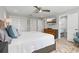 Bright bedroom featuring a ceiling fan, ample closet space, and a contemporary style at 6912 S Atlantic Ave, New Smyrna Beach, FL 32169