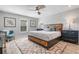 Well-lit bedroom with a stylish ceiling fan, natural light and modern furniture at 6912 S Atlantic Ave, New Smyrna Beach, FL 32169