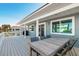Outdoor deck with dining set, showcasing a relaxed setting with clear blue skies above at 6912 S Atlantic Ave, New Smyrna Beach, FL 32169
