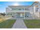 Charming home featuring a covered patio, well-maintained lawn, and beautiful paver walkway at 6912 S Atlantic Ave, New Smyrna Beach, FL 32169