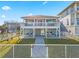 Charming beach house with a welcoming fenced yard, beautiful landscaping and inviting facade at 6912 S Atlantic Ave, New Smyrna Beach, FL 32169