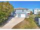 Two-car garage and light blue exterior house at 6912 S Atlantic Ave, New Smyrna Beach, FL 32169