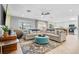 Spacious living room with a comfortable sectional sofa, stylish rug, and adjacent dining area at 6912 S Atlantic Ave, New Smyrna Beach, FL 32169