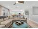 Bright living room featuring a sectional sofa, modern ceiling fan, and open floor plan at 6912 S Atlantic Ave, New Smyrna Beach, FL 32169