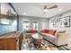 Comfortable living room features large screen TV, neutral walls, ceiling fan, and a decorative area rug at 6912 S Atlantic Ave, New Smyrna Beach, FL 32169