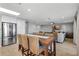 Kitchen flows into the living room with a large dining room table with lots of seating at 6912 S Atlantic Ave, New Smyrna Beach, FL 32169