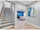 Staircase leading to living area with blue accent wall at 6912 S Atlantic Ave, New Smyrna Beach, FL 32169