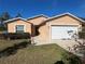 Front view of a house with a landscaped yard and attached garage at 7375 Holly Creek Rd, Mount Dora, FL 32757