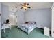 Relaxing bedroom with green carpeting, ceiling fan, and ample space for furniture at 817 W 9Th St, Deltona, FL 32725