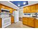 Kitchen with wood cabinets, granite counters, and blue ceiling at 817 W 9Th St, Deltona, FL 32725