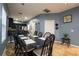 Dining room with a dark wood table and chairs, adjacent to the kitchen at 8747 Isla Bella Dr, Orlando, FL 32818