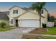 Two-story house with a two car garage at 8747 Isla Bella Dr, Orlando, FL 32818