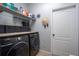 Laundry room with washer, dryer, and shelving at 8747 Isla Bella Dr, Orlando, FL 32818