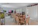 Bright dining room features a wood table and chairs, adjacent to a spacious living area at 887 Panical Dr, Apopka, FL 32703