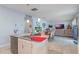 Kitchen island with double sink, and seating overlooking living area at 887 Panical Dr, Apopka, FL 32703