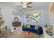 Living room with blue velvet sofa, gold accents, and a Christmas tree at 887 Panical Dr, Apopka, FL 32703