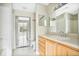 Bathroom with light wood cabinets and a large mirror at 8981 Lee Vista Blvd # 2209, Orlando, FL 32829