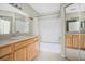 Bathroom with a shower/tub combo and wood cabinets at 8981 Lee Vista Blvd # 2209, Orlando, FL 32829