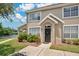 Two-story townhome with a lake view and landscaped front yard at 8981 Lee Vista Blvd # 2209, Orlando, FL 32829