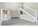 Bright living room featuring gray vinyl flooring and a modern staircase at 8981 Lee Vista Blvd # 2209, Orlando, FL 32829