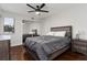 Bedroom with gray bedding, wood floors, and ceiling fan at 282 S Fox Chase Pt, Longwood, FL 32779