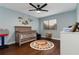 Bedroom with crib, alphabet rug, and wood flooring at 282 S Fox Chase Pt, Longwood, FL 32779