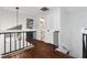 Upstairs hallway with dark wood flooring and modern railing at 282 S Fox Chase Pt, Longwood, FL 32779