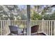 Relaxing balcony with wicker chairs and tranquil wooded views at 1087 Park Ridge Cir, Kissimmee, FL 34746