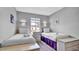 Well-lit bedroom featuring two twin beds, nightstands, and a window with a view at 1087 Park Ridge Cir, Kissimmee, FL 34746