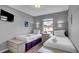 Bright bedroom with two twin beds, nightstands, and a window offering natural light at 1087 Park Ridge Cir, Kissimmee, FL 34746