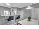 Modern dining area with white table and clear chairs at 1087 Park Ridge Cir, Kissimmee, FL 34746