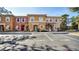 Three-unit townhome building with parking and landscaping at 1087 Park Ridge Cir, Kissimmee, FL 34746