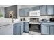 Modern kitchen with stainless steel appliances and white countertops at 1087 Park Ridge Cir, Kissimmee, FL 34746