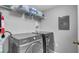 Laundry room with washer, dryer, and shelving for storage at 1087 Park Ridge Cir, Kissimmee, FL 34746