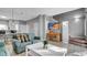 Living room with teal couch, home office area, and stairs at 1087 Park Ridge Cir, Kissimmee, FL 34746