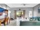 Living room with teal couch, patio access, and a home office area at 1087 Park Ridge Cir, Kissimmee, FL 34746
