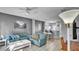 Living room, dining area, and kitchen with teal couches at 1087 Park Ridge Cir, Kissimmee, FL 34746