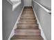 Stairs with wood laminate treads and gray walls at 1087 Park Ridge Cir, Kissimmee, FL 34746