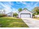 White single story house with a two car garage and lush lawn at 122 Baywest Dr, Orlando, FL 32835