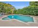 Inviting kidney-shaped pool with surrounding landscaping at 137 S Deerwood Ave, Orlando, FL 32825